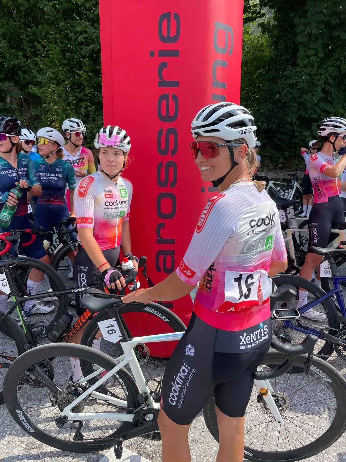 Team Cookina Graz riders with race numbers at the start arch of the Gaisberg hill climb